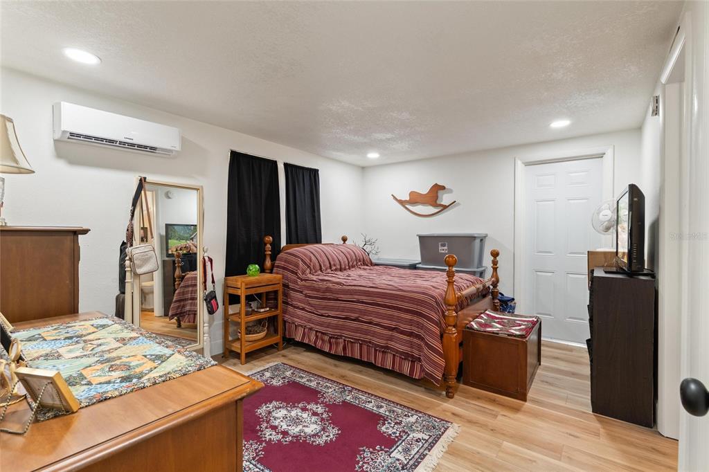 5707 Tennessee Avenue New Port Richey, FL 34652 - Photo 8 of 26 a bedroom with a bed and a dresser