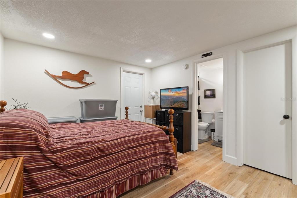 5707 Tennessee Avenue New Port Richey, FL 34652 - Photo 9 of 26 a bedroom with a bed and a television