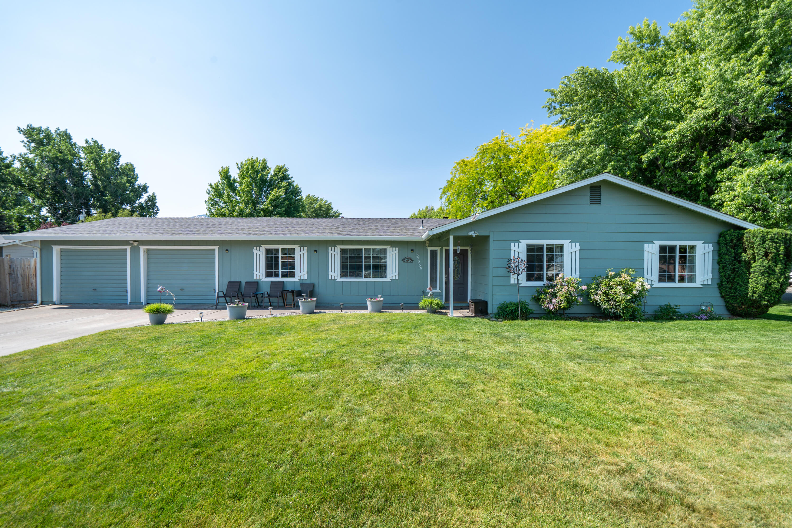 a front view of house with a garden and patio