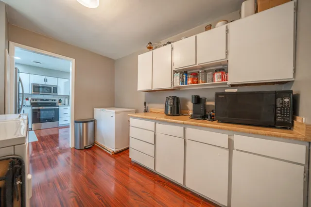 a kitchen with stainless steel appliances granite countertop a refrigerator and microwave