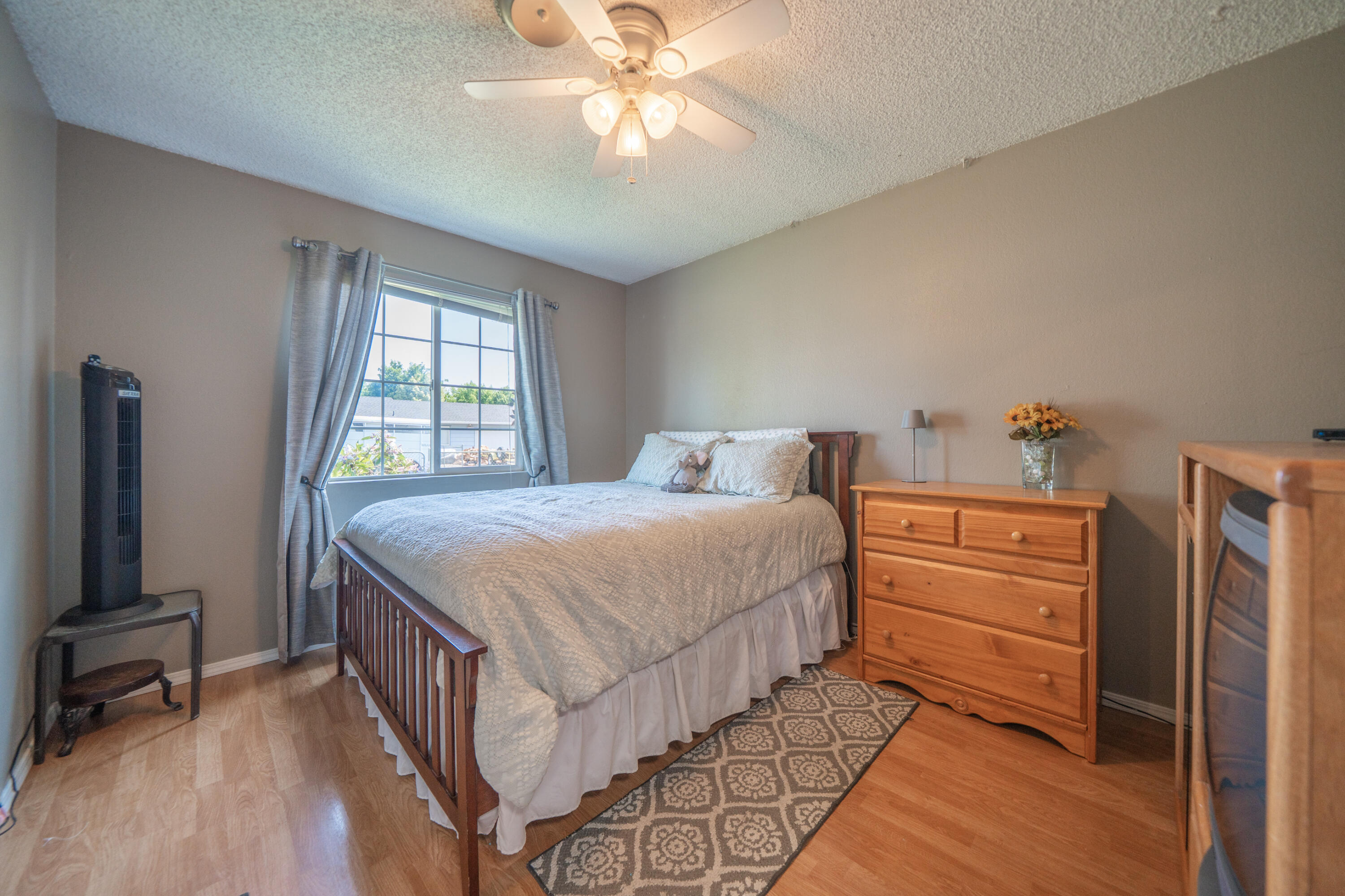 37255 Carson Street Burney, CA 96013 - Photo 21 of 40 a bedroom with a bed and a chandelier