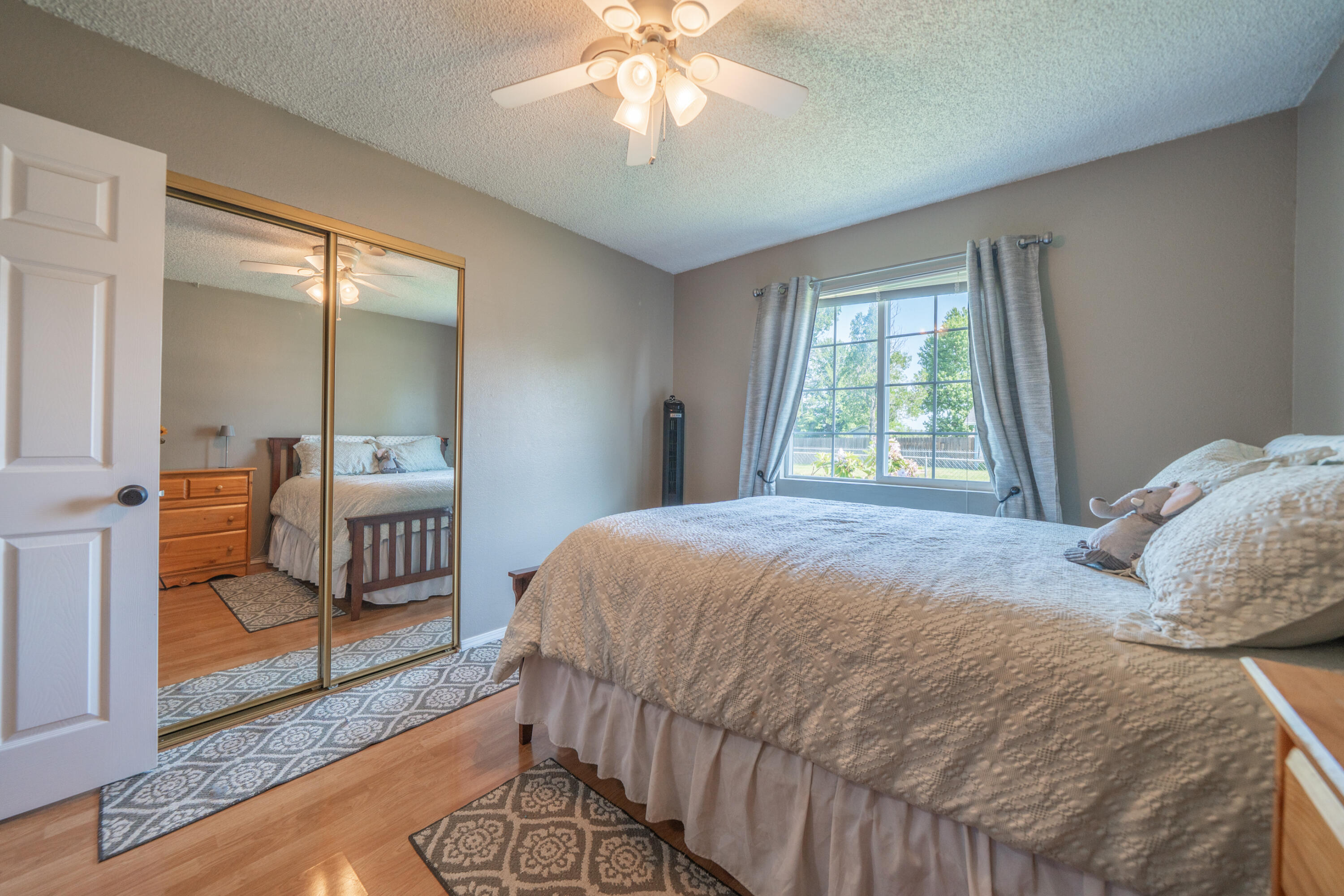 37255 Carson Street Burney, CA 96013 - Photo 22 of 40 a bedroom with a bed a chandelier and mirror