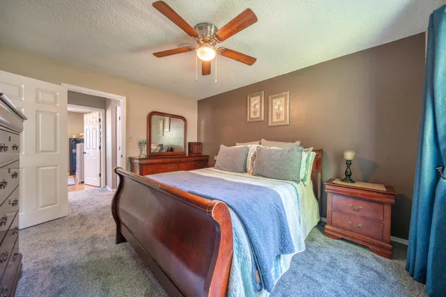 a bed room with a bed and a chandelier