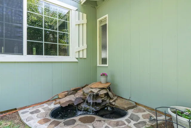 a room with a wooden floor and a potted plant