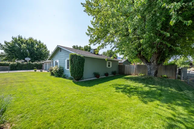 a front view of house with yard and green space