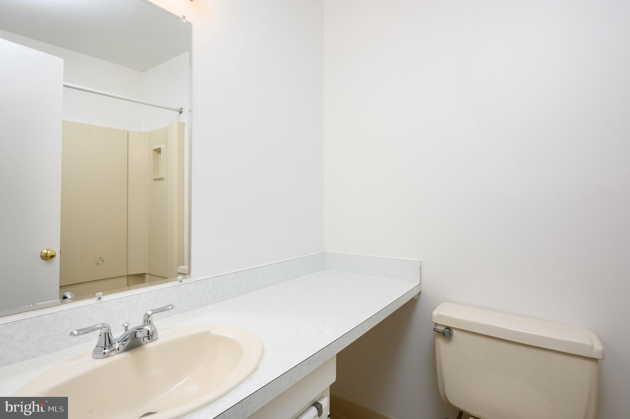 2060 Headlands Circle Reston, VA 20191 - Photo 16 of 26 a bathroom with a sink a toilet and a mirror