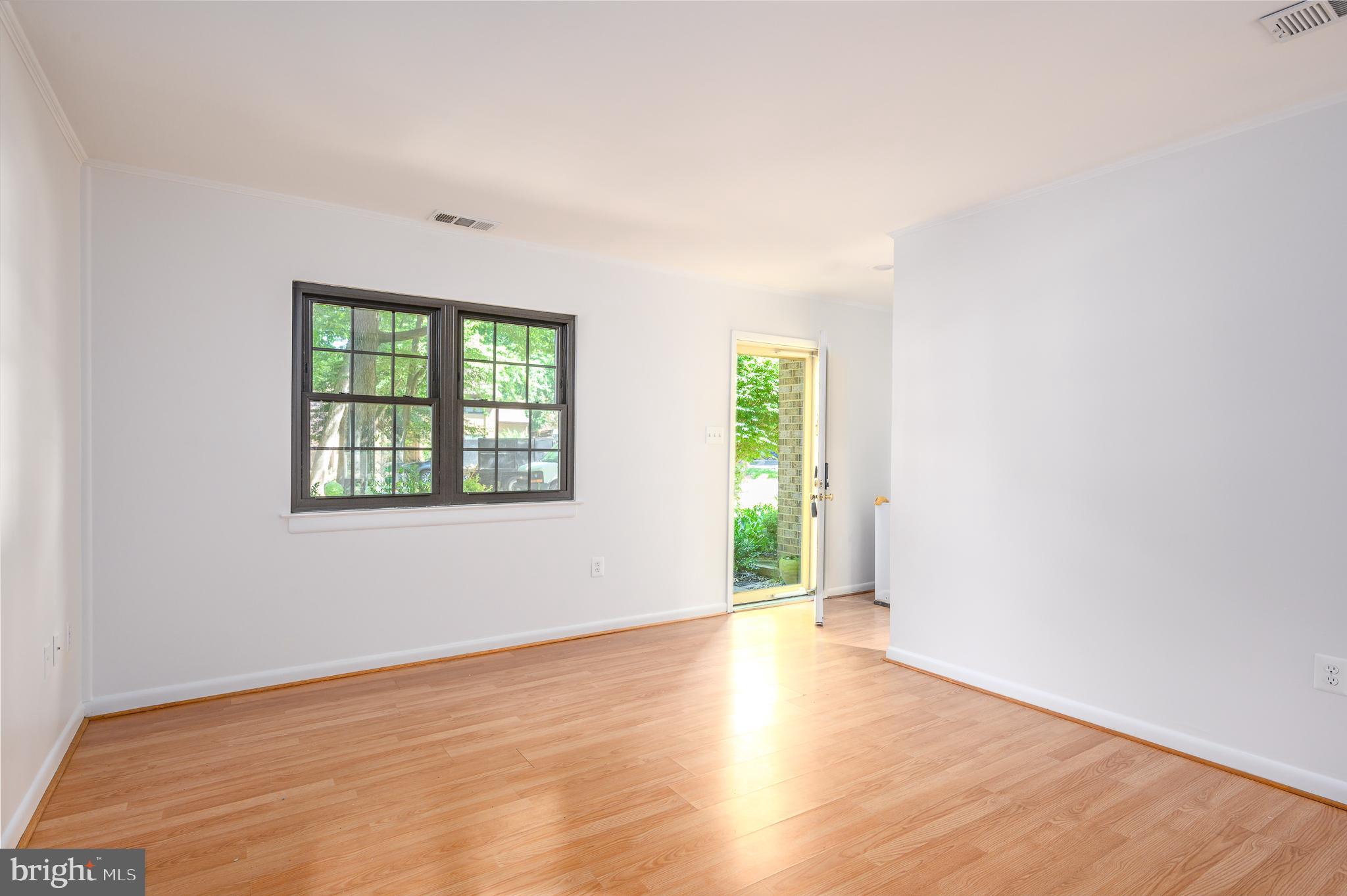 2060 Headlands Circle Reston, VA 20191 - Photo 3 of 26 an empty room with wooden floor and windows