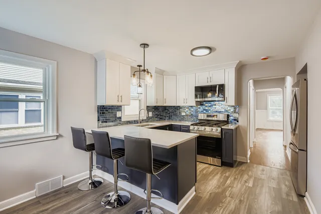 a kitchen with a stove a sink and a refrigerator