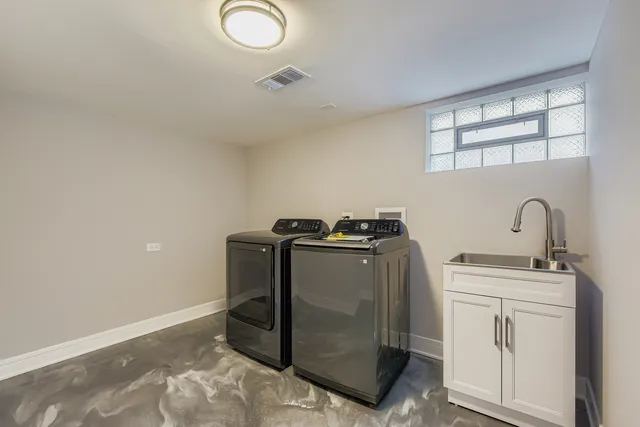 a utility room with closet dryer and washer