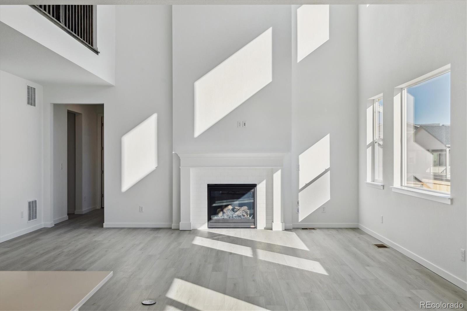 2572 West Bitterroot Place Highlands Ranch, CO 80129 - Photo 11 of 30 an empty room with windows and fireplace