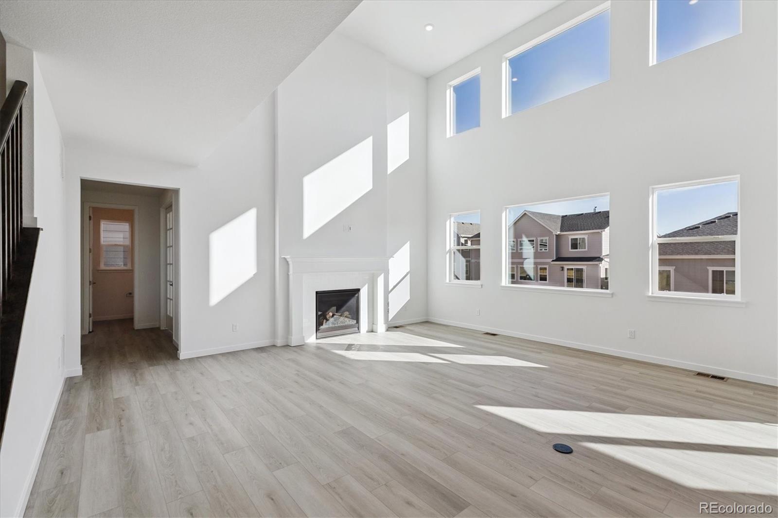 2572 West Bitterroot Place Highlands Ranch, CO 80129 - Photo 12 of 30 a view of empty room with wooden floor and fireplace