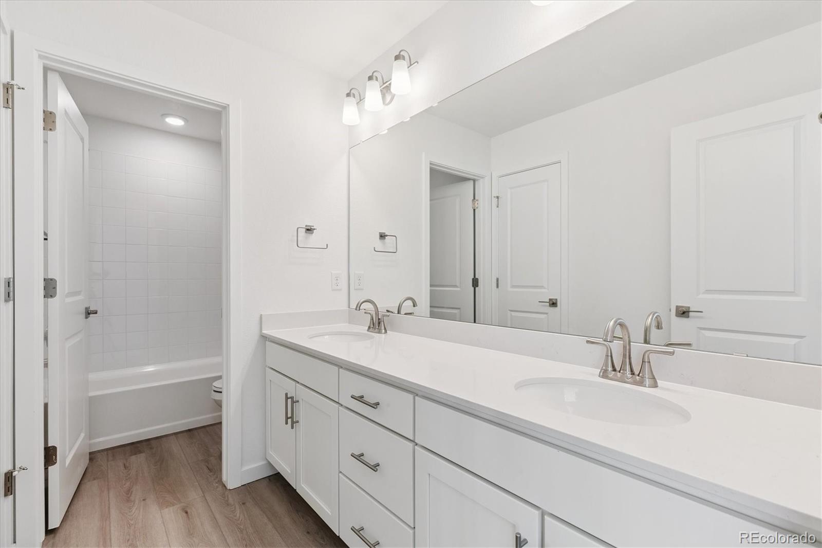 2572 West Bitterroot Place Highlands Ranch, CO 80129 - Photo 22 of 30 a bathroom with a sink double vanity granite tub and shower