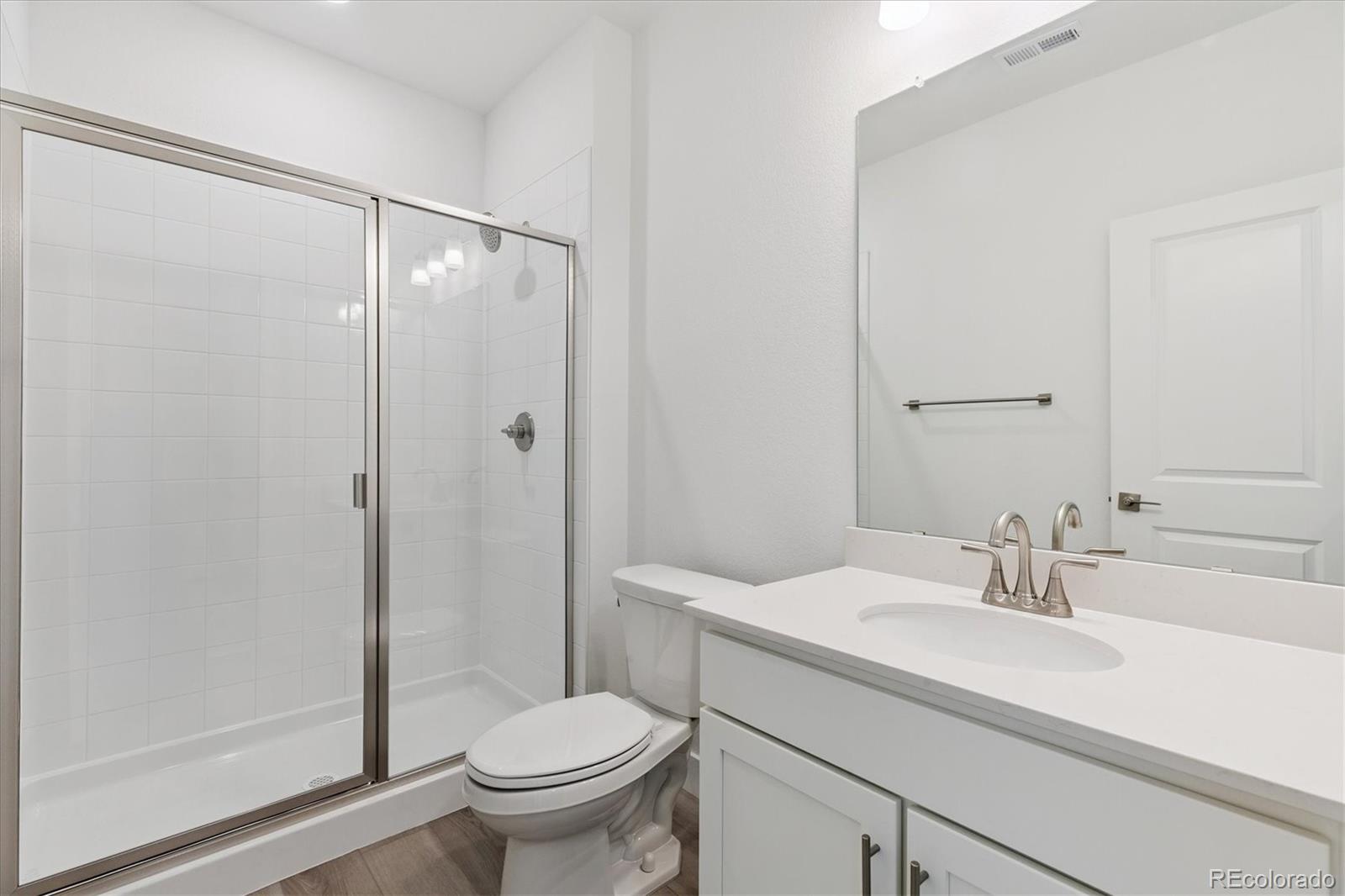 2572 West Bitterroot Place Highlands Ranch, CO 80129 - Photo 26 of 30 a bathroom with a sink toilet and shower