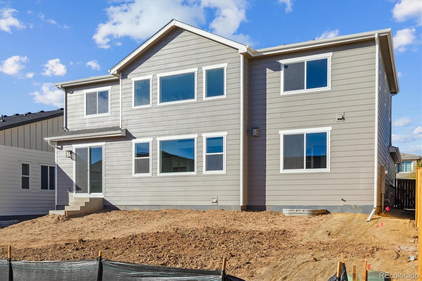 2572 West Bitterroot Place Highlands Ranch, CO 80129 - Photo 27 of 30 a front view of a house with a yard