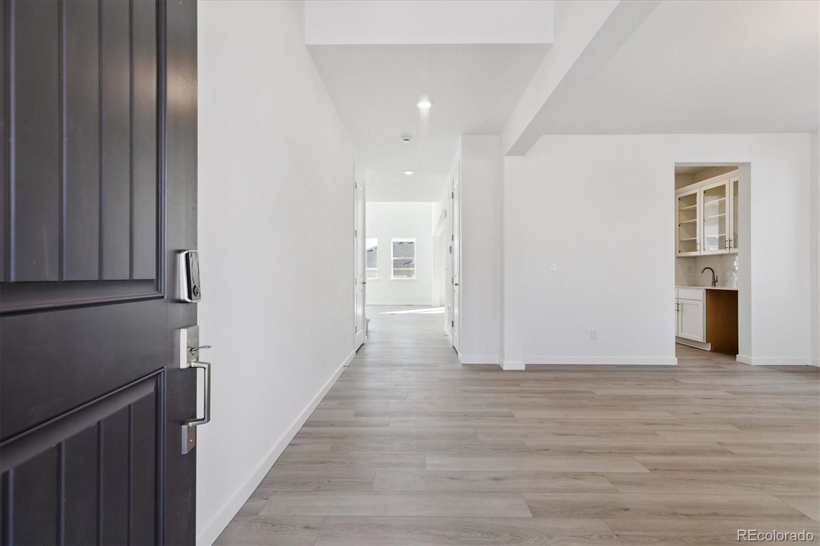2572 West Bitterroot Place Highlands Ranch, CO 80129 - Photo 3 of 30 a view of a hallway with wooden floor