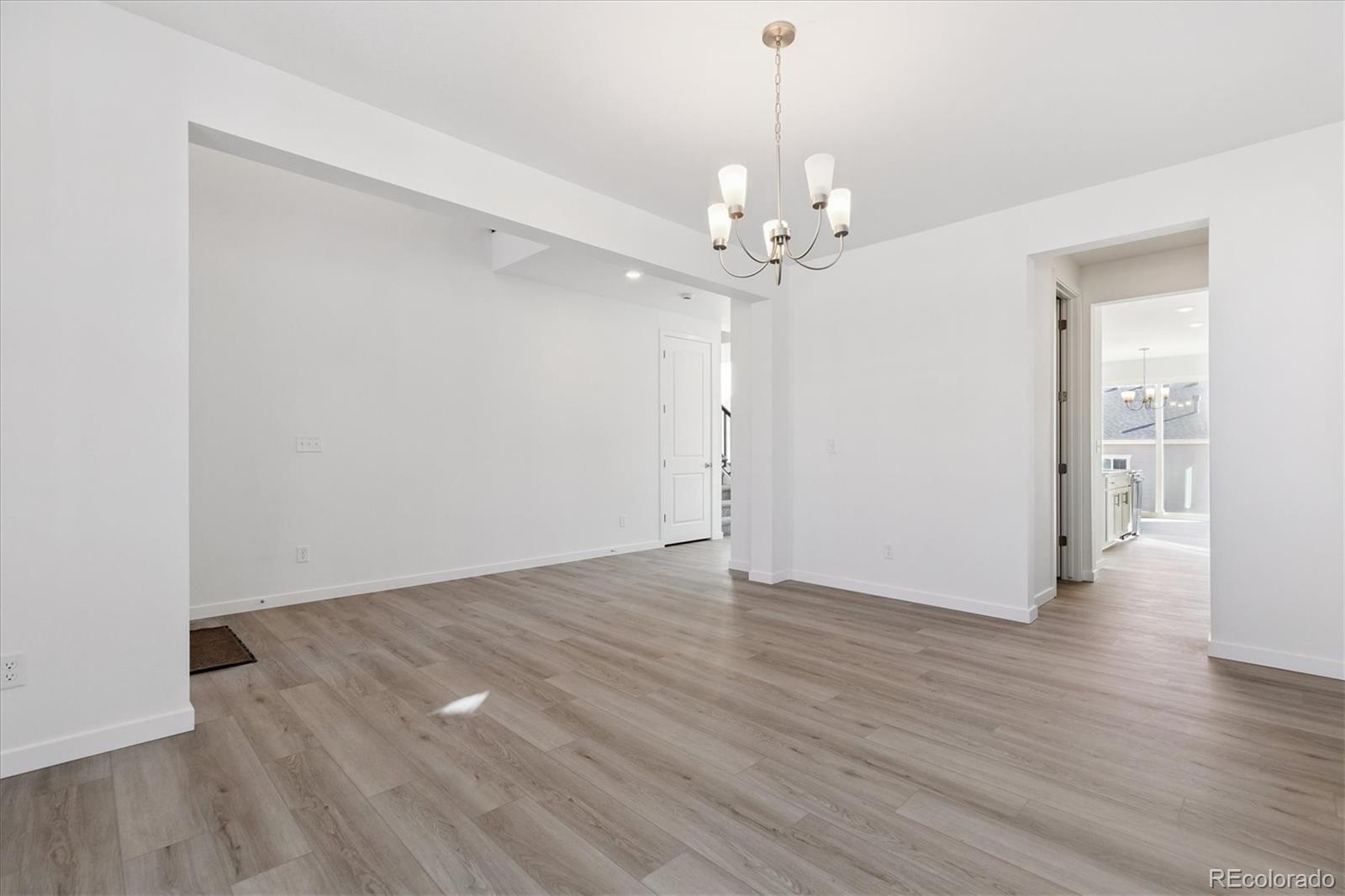 2572 West Bitterroot Place Highlands Ranch, CO 80129 - Photo 5 of 30 wooden floor in an empty room with a window
