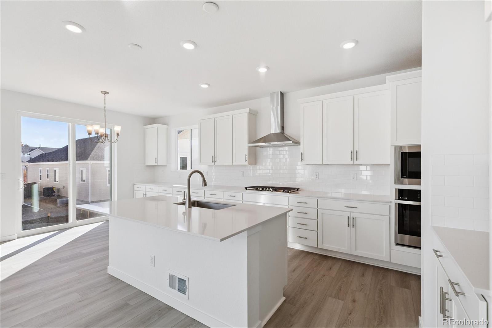 2572 West Bitterroot Place Highlands Ranch, CO 80129 - Photo 7 of 30 a kitchen with stainless steel appliances granite countertop a sink stove and refrigerator