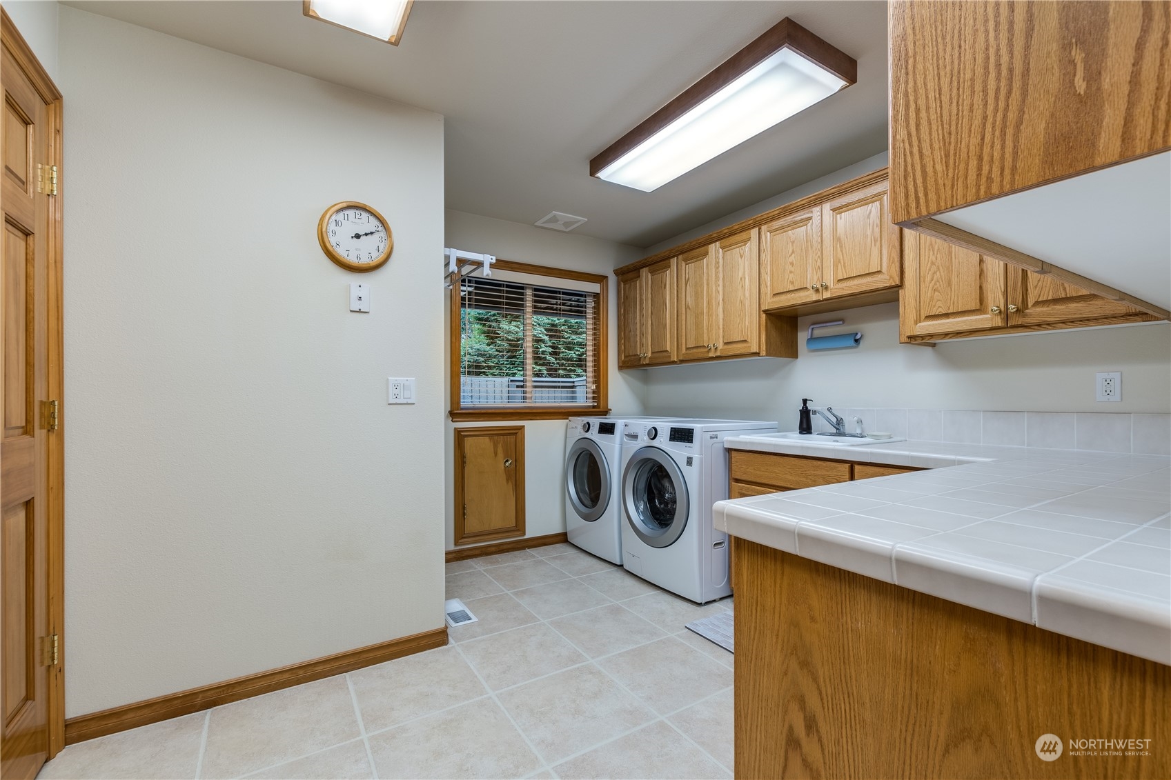 5447 Canvasback Road Blaine, WA 98230 - Photo 13 of 40 a utility room with a sink a washer and dryer