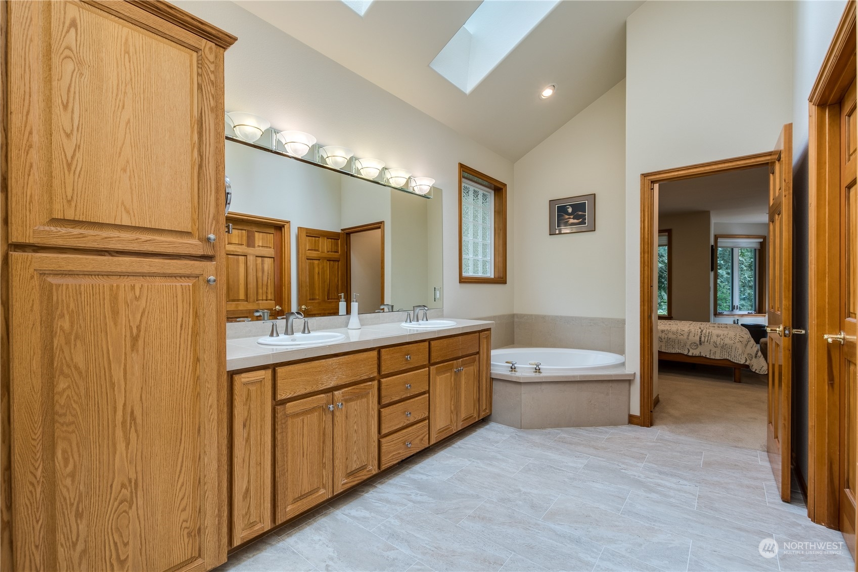 5447 Canvasback Road Blaine, WA 98230 - Photo 20 of 40 a spacious bathroom with a double vanity sink a large mirror and a bathtub