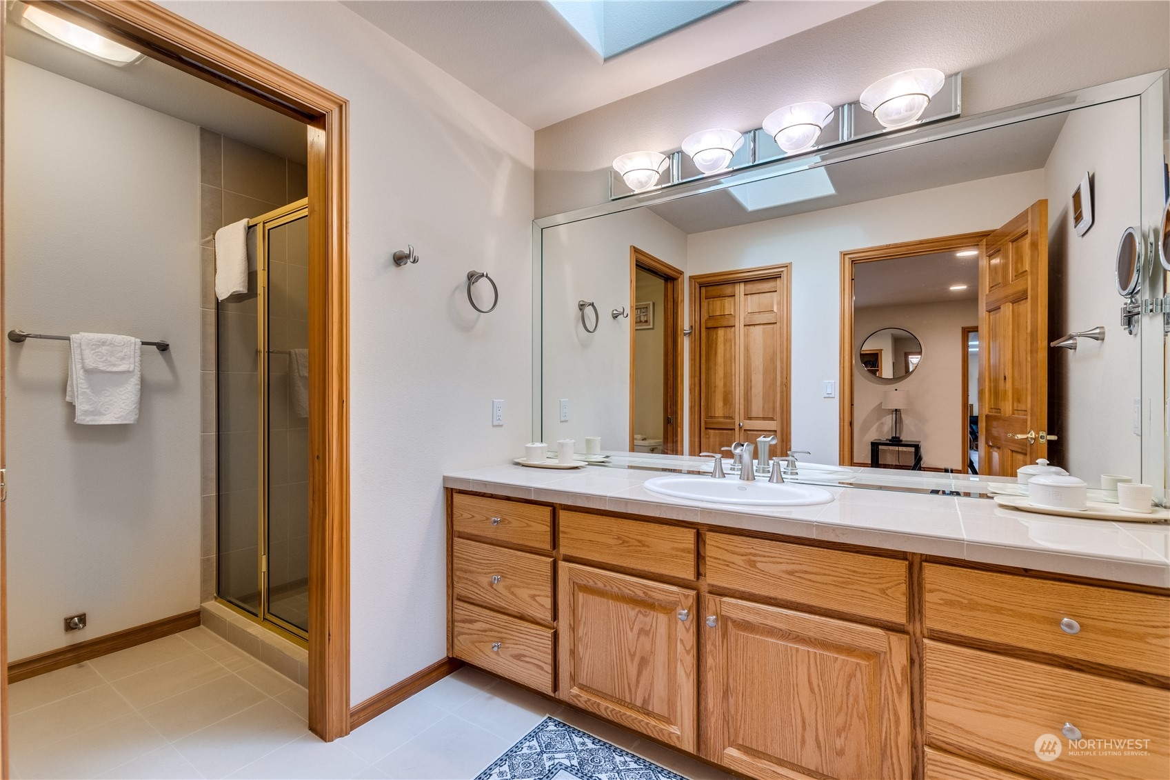 5447 Canvasback Road Blaine, WA 98230 - Photo 25 of 40 a bathroom with a double vanity sink and a mirror
