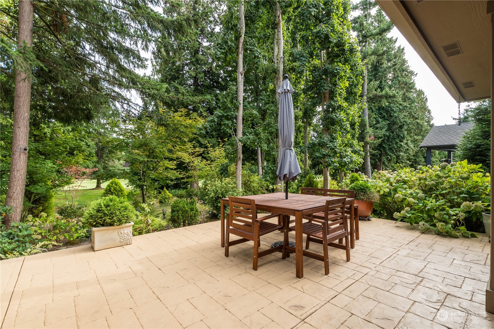 5447 Canvasback Road Blaine, WA 98230 - Photo 31 of 40 a view of a patio with table and chairs and potted plants