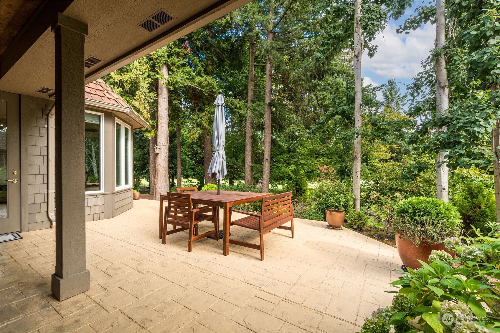 5447 Canvasback Road Blaine, WA 98230 - Photo 32 of 40 a patio with yard glass top table and chairs