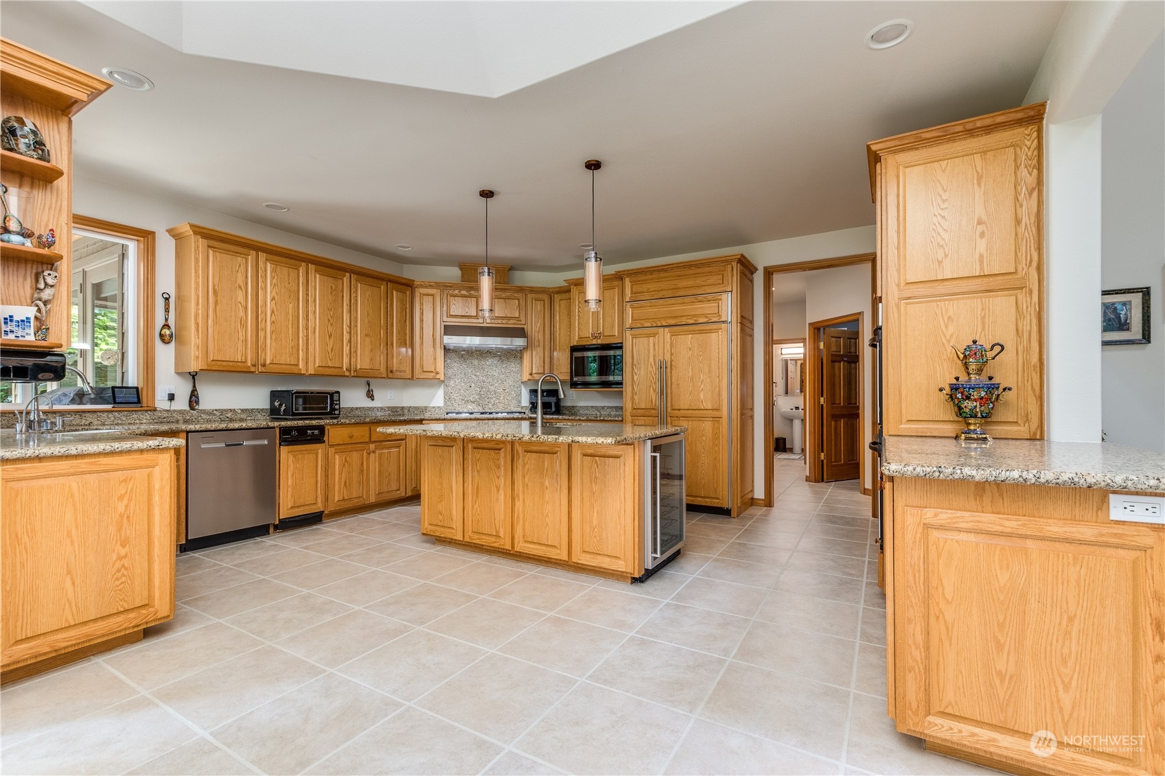 5447 Canvasback Road Blaine, WA 98230 - Photo 8 of 40 a kitchen with stainless steel appliances granite countertop a stove a sink dishwasher a refrigerator and cabinets with wooden floor