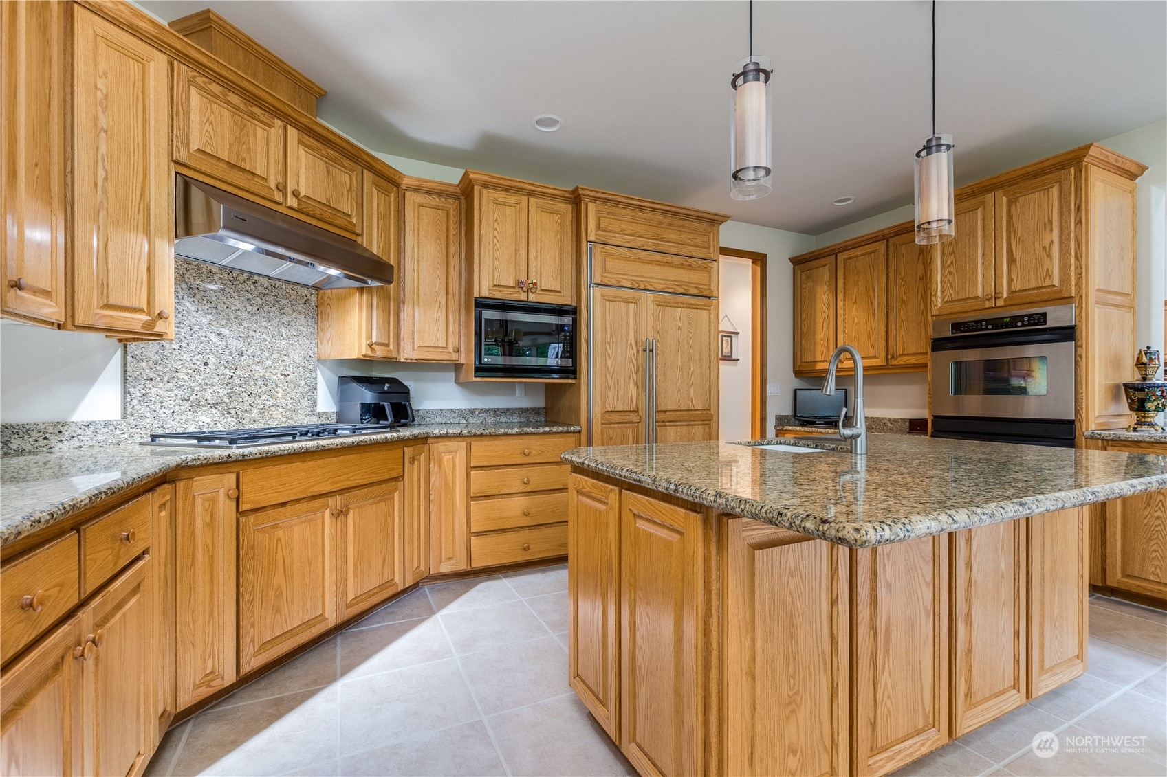 5447 Canvasback Road Blaine, WA 98230 - Photo 9 of 40 a kitchen with stainless steel appliances granite countertop a sink a stove and cabinets