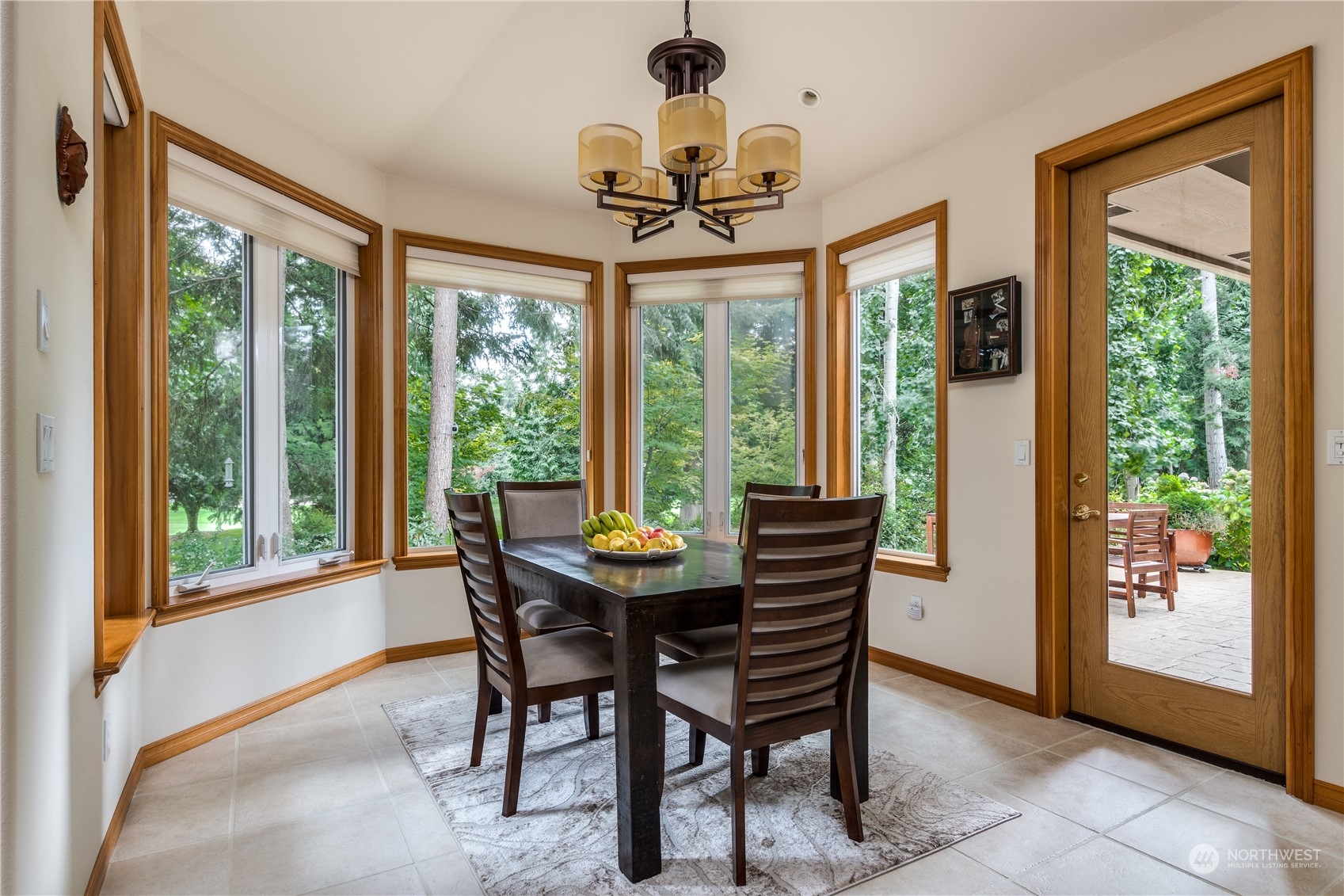 5447 Canvasback Road Blaine, WA 98230 - Photo 10 of 40 a dining room with chandelier a glass table and chairs