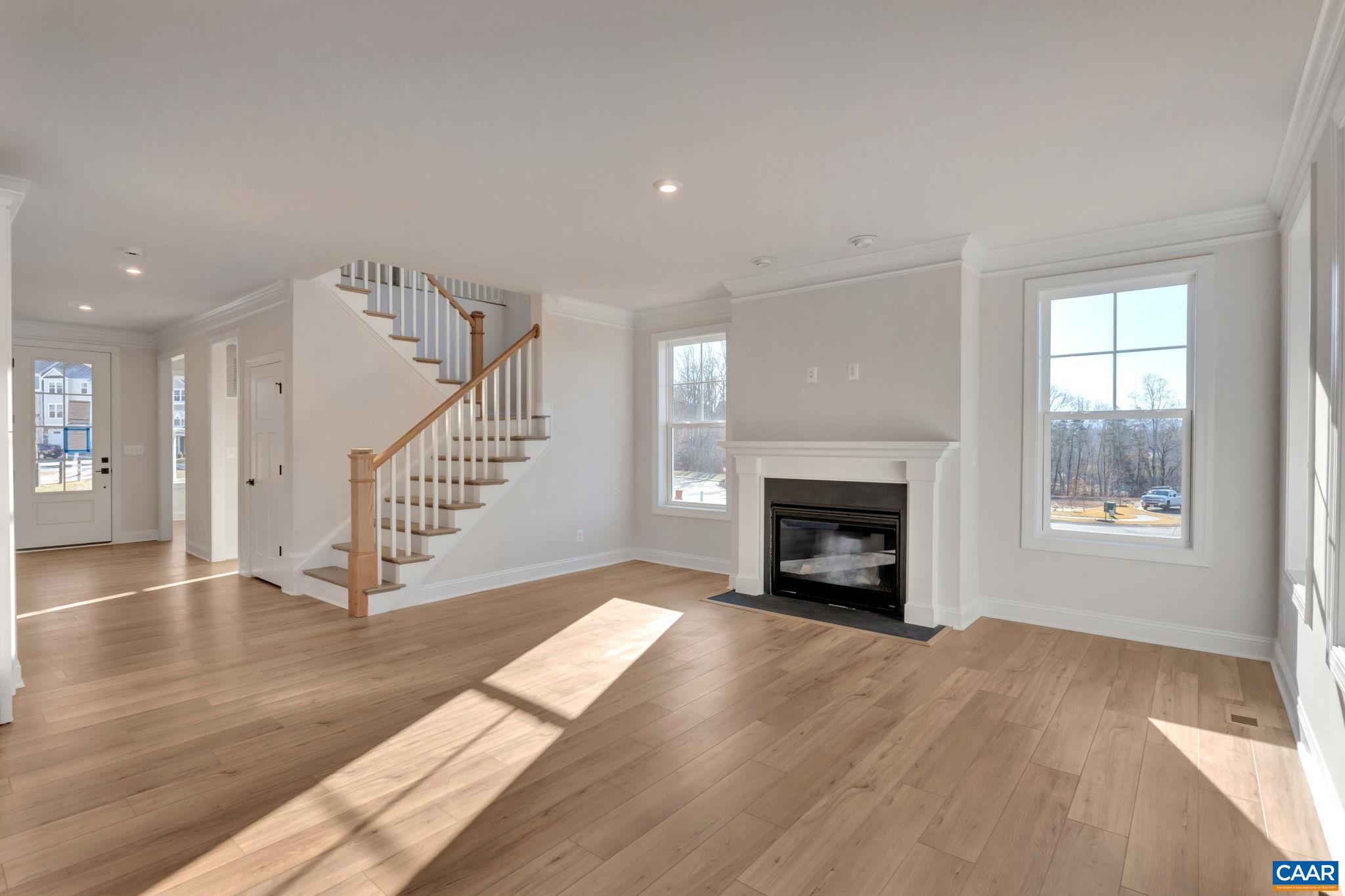 109 B Marcella Street Charlottesville, VA 22911 - Photo 11 of 36 a view of an empty room with wooden floor fireplace and a window