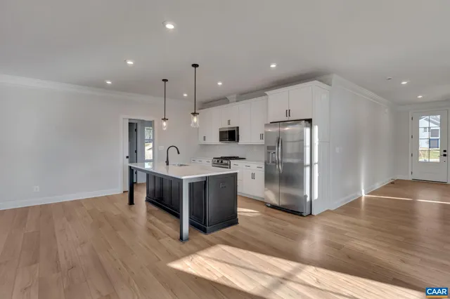 a kitchen with stainless steel appliances a refrigerator and a sink