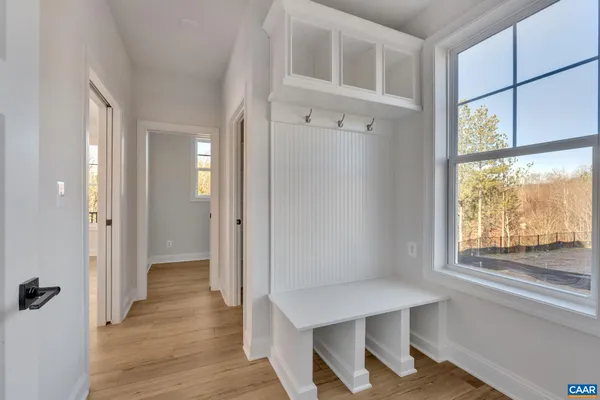 a view of a room with wooden floor and windows