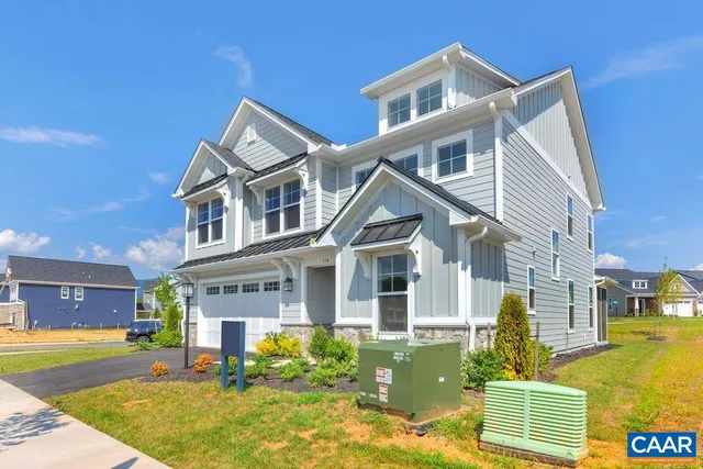 a front view of a house with a yard table and chairs