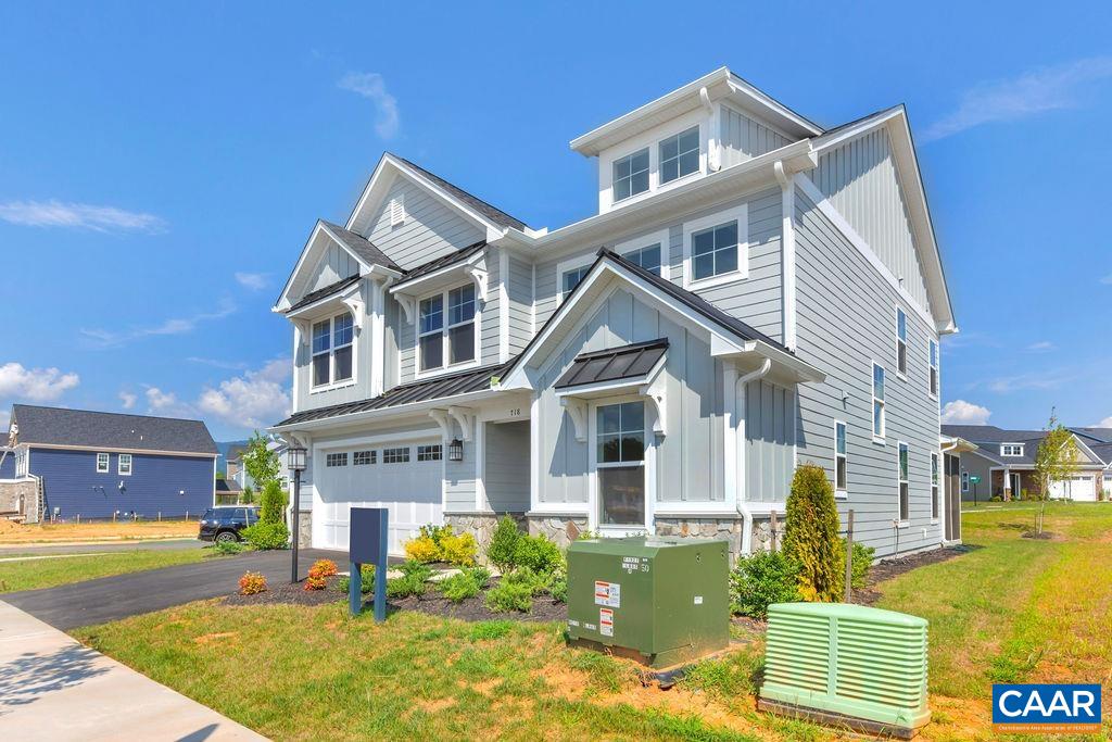 109 B Marcella Street Charlottesville, VA 22911 - Photo 2 of 36 a front view of a house with a yard table and chairs
