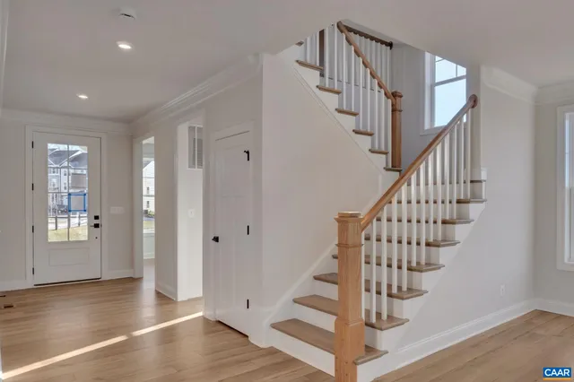 a view of entryway with wooden floor and stairs