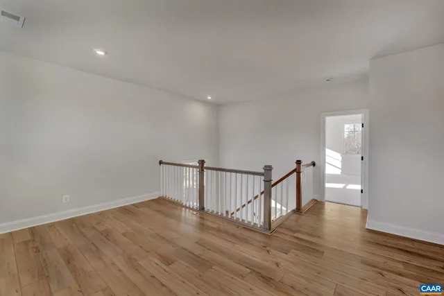 a view of hallway with wooden floor
