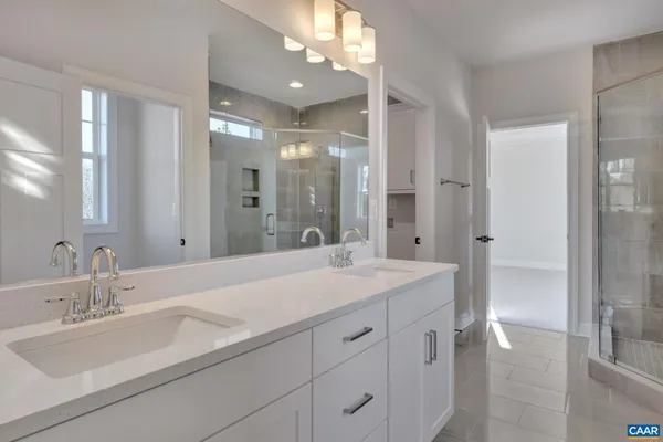 a bathroom with a sink double vanity granite tub and shower