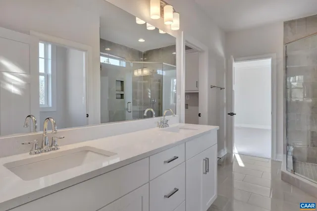 a bathroom with a sink double vanity granite tub and shower