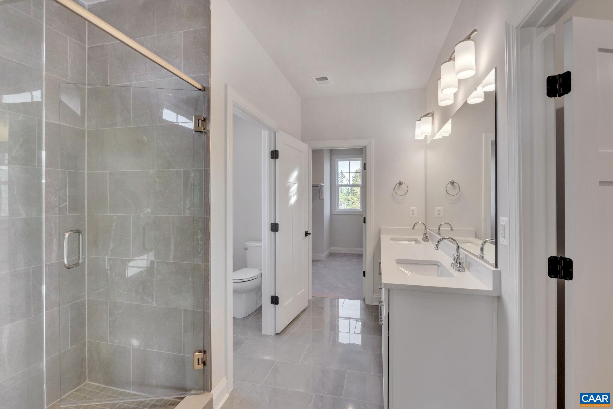 109 B Marcella Street Charlottesville, VA 22911 - Photo 27 of 36 a bathroom with a double vanity sink and shower