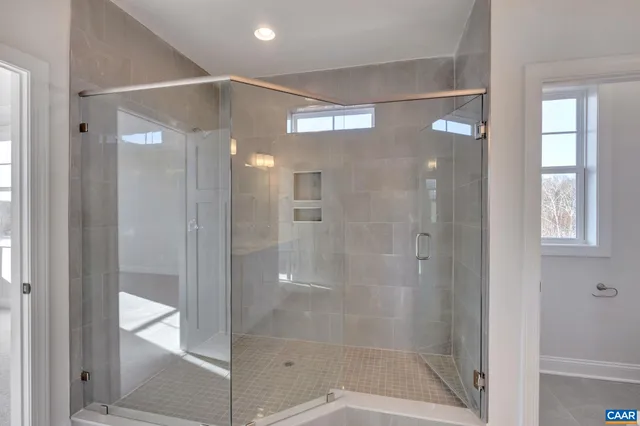 a bathroom with a glass shower door