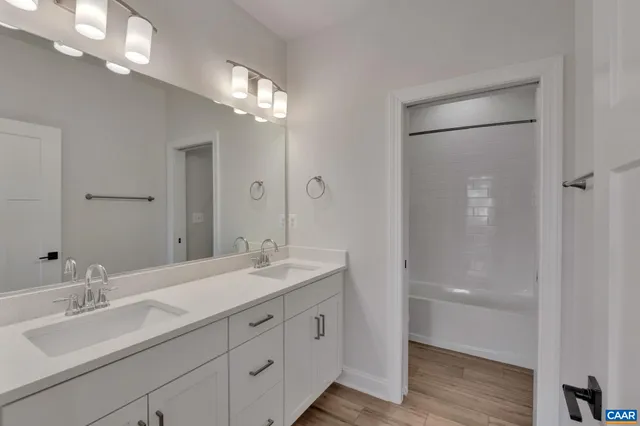 a bathroom with a double vanity sink and a mirror