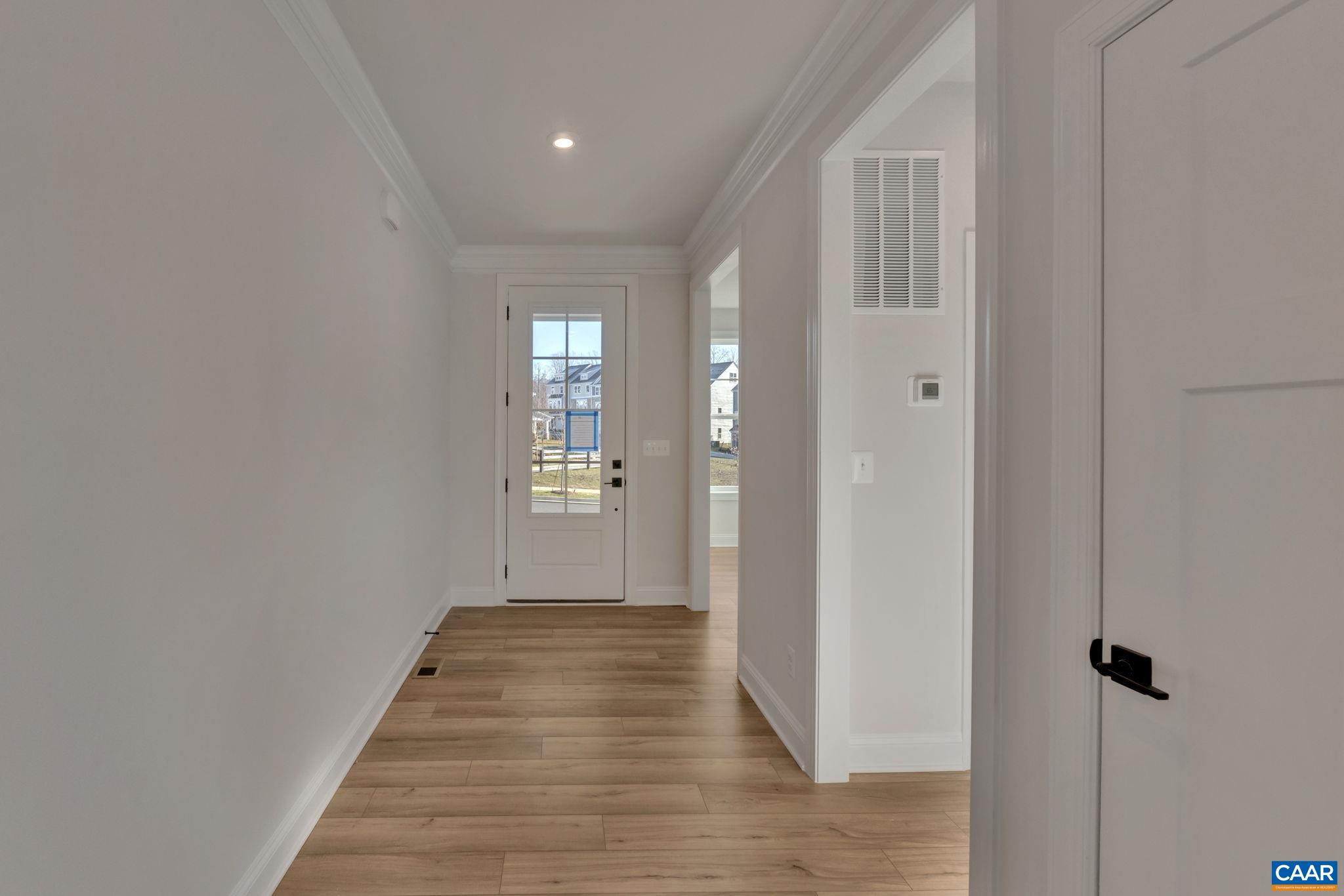 109 B Marcella Street Charlottesville, VA 22911 - Photo 4 of 36 a view of a hallway with wooden floor and a bathroom