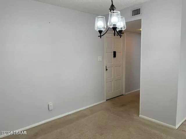 en empty room with windows and fan