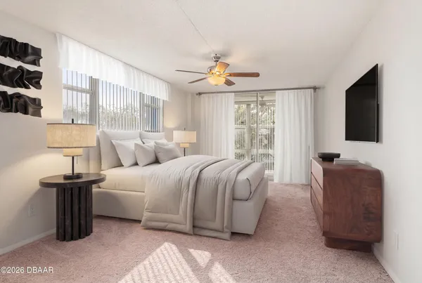 en empty room with windows and fan