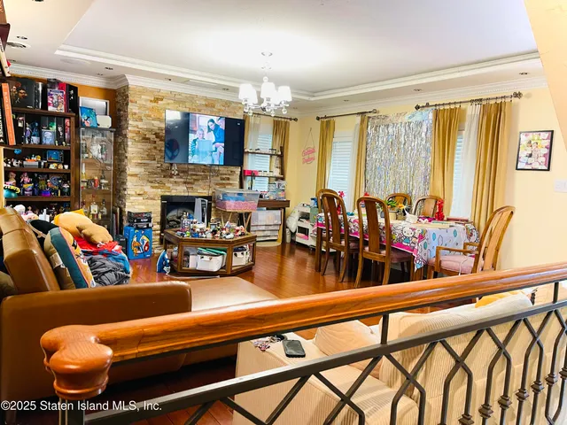 a living room with lots of furniture and a large window