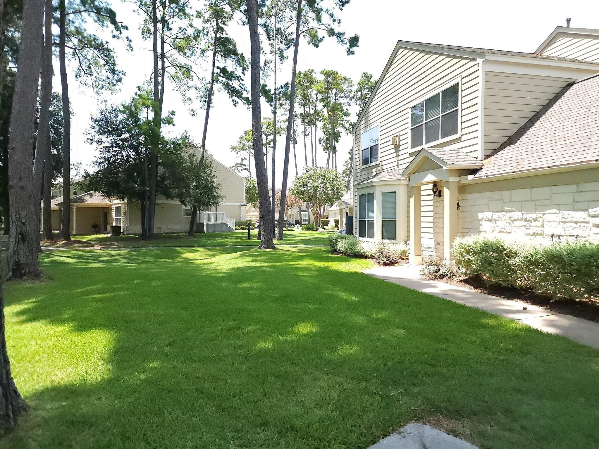 13600 Breton Ridge Street, Unit 24A Houston, TX 77070 - Photo 22 of 24 a view of a house with a big yard and large tree