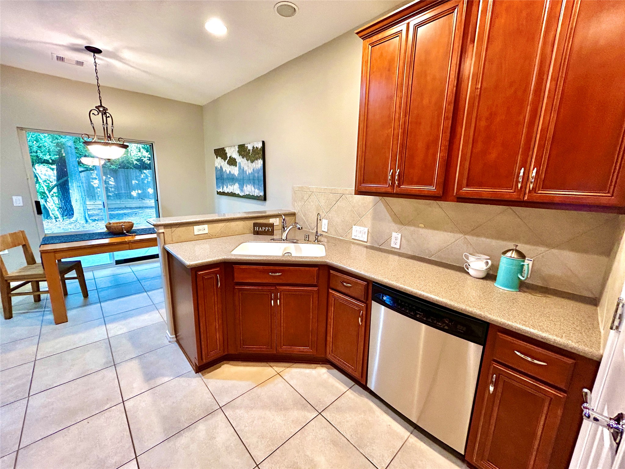 13600 Breton Ridge Street, Unit 24A Houston, TX 77070 - Photo 10 of 24 a kitchen with stainless steel appliances granite countertop a sink dishwasher stove and cabinets