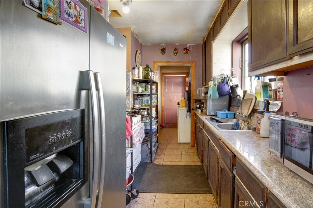 2001 Berkeley Avenue Los Angeles, CA 90026 - Photo 6 of 40 a kitchen with stainless steel appliances granite countertop a refrigerator and a sink
