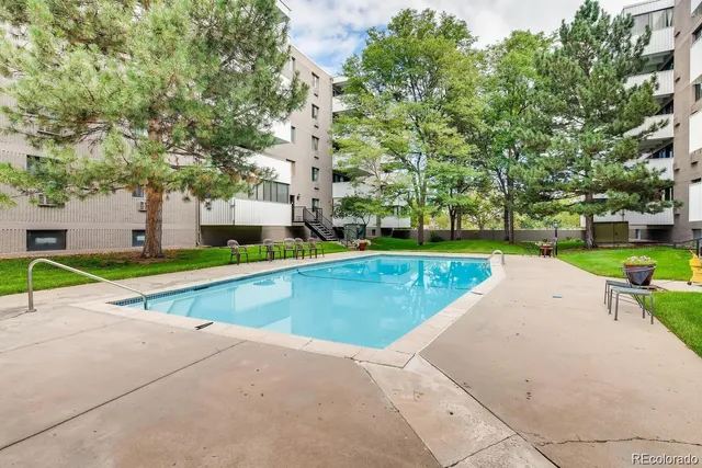 a view of yard with swimming pool and green space