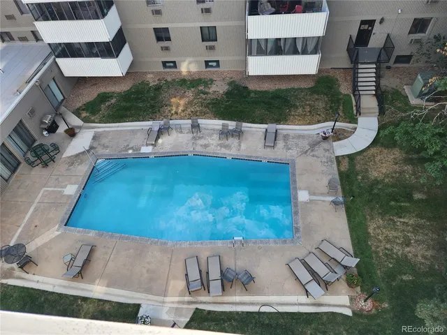 a view of a cars park in front of a building